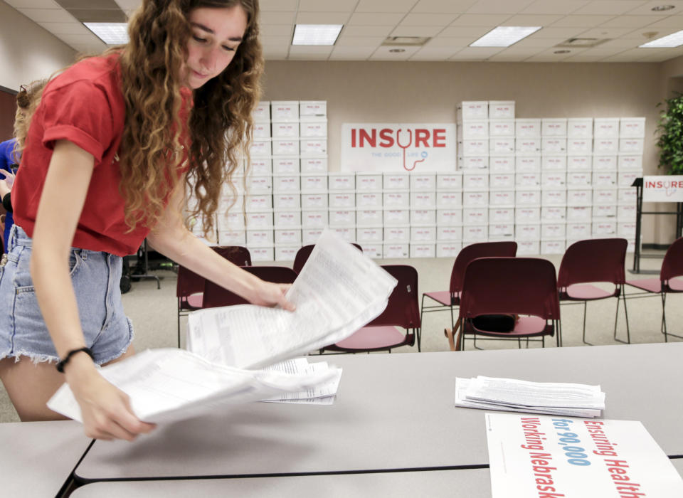 Volunteer Allie Christianson sorts petitions in Lincoln, Neb., in July 2018. The group Insure the Good Life, seeking to expand Medicaid in Nebraska, announced it had gathered more than 133,000 signatures, well above the required minimum of 85,000 to place the issue on the November general-election ballot. (Photo: Nati Harnik/AP)