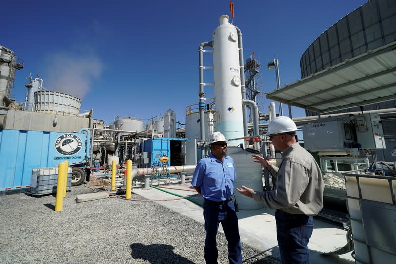 Calgren Environmental, Health and Safety Coordinator Paul Lopez talks with SoCalGas project manager Ty Korenwinder at the Calgren methane recycling plant in Pixley