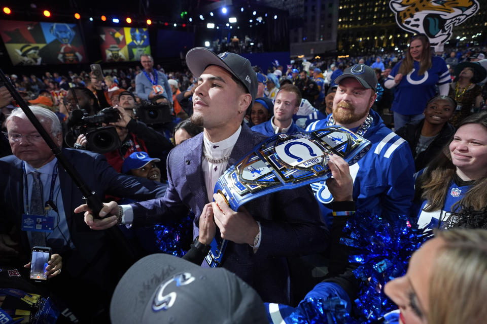 UCLA defensive lineman Laiatu Latu poses with fans after being chosen by the Indianapolis Colts with the 15th overall pick during the first round of the NFL football draft, Thursday, April 25, 2024, in Detroit. (AP Photo/Paul Sancya)