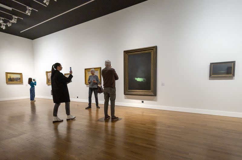 Visitors look at paintings from the collection of the National Art Gallery of Kyiv during the "From Dusk To Dawn" exhibition at the Rath Museum in Geneva