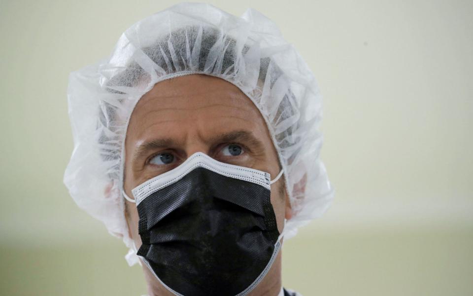 rench President Emmanuel Macron looks on as he visits the Delpharm plant in Saint-Remy-sur-Avre, west of Paris on April 9