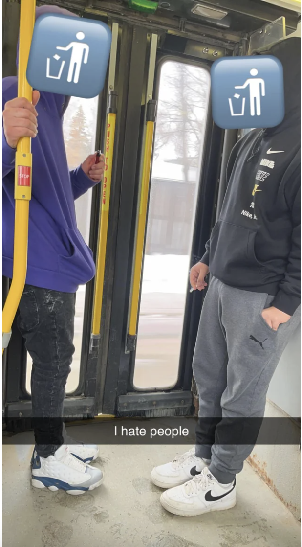 Person smoking just inside the back door of a bus