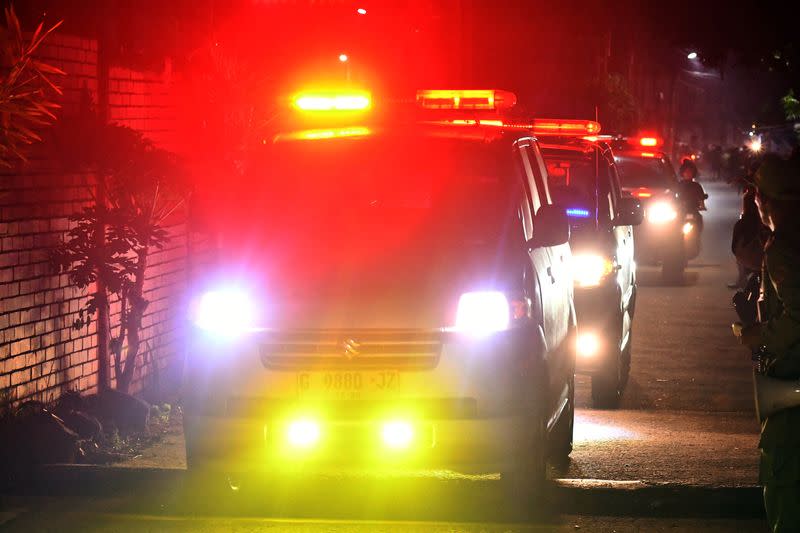 Ambulance stands by during a massive fire that broke out at a military ammunition facility in Bekasi