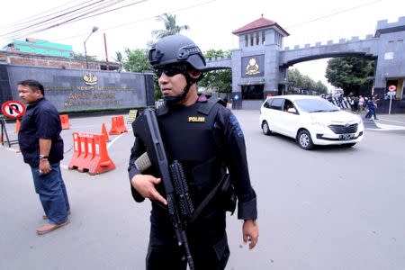 FILE PHOTO - A police officer stands guard outside the Mobile Police Brigade or Brimob headquarters, where former Jakarta governor Basuki Tjahaja Purnama, popularly known as Ahok, is currently being detained in, Depok, south of Jakarta, Indonesia May 10, 2017 in this photo taken by Antara Foto. Antara Foto/Yulius Satria Wijaya/File Photo via REUTERS