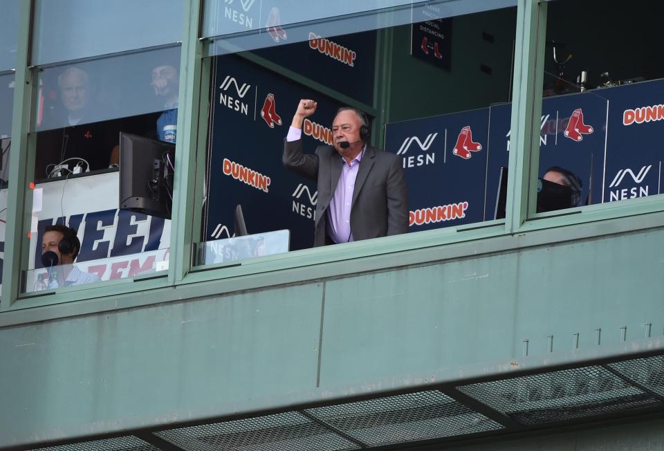 Boston Red Sox broadcaster Jerry Remy signals to former second baseman Dustin Pedoria during pregame ceremonies in Pedoria's honor prior to a game against the New York Yankees at Fenway Park.