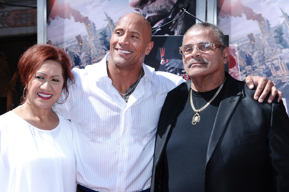 Dwayne Johnson with parents Ata Johnson and Rocky Johnson at his hand and footprint ceremony held at the TCL Chinese Theatre on Tuesday, May 19, 2015. (Photo by Richard Shotwell/Invision/AP)