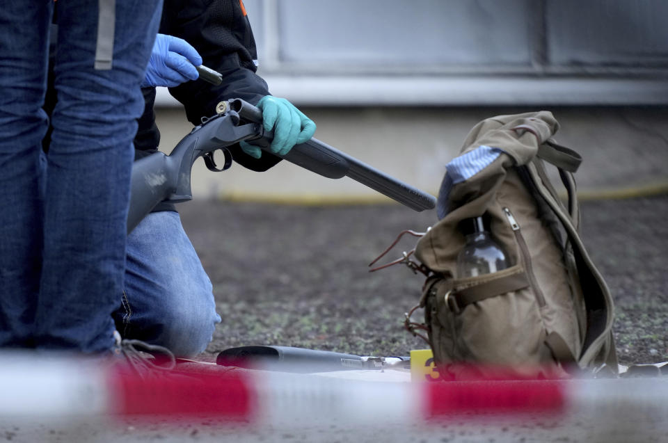 Police officers secure traces on the grounds of the Heidelberg University Botanical Garden in Heidelberg, Germany, Monday, Jan. 24, 2022. German police say a lone gunman wounded several people at a lecture theatre in the southwest city of Heidelberg on Monday. Police said in a brief statement that the perpetrator was dead but didn't give details of how that happened.(AP Photo/Michael Probst)