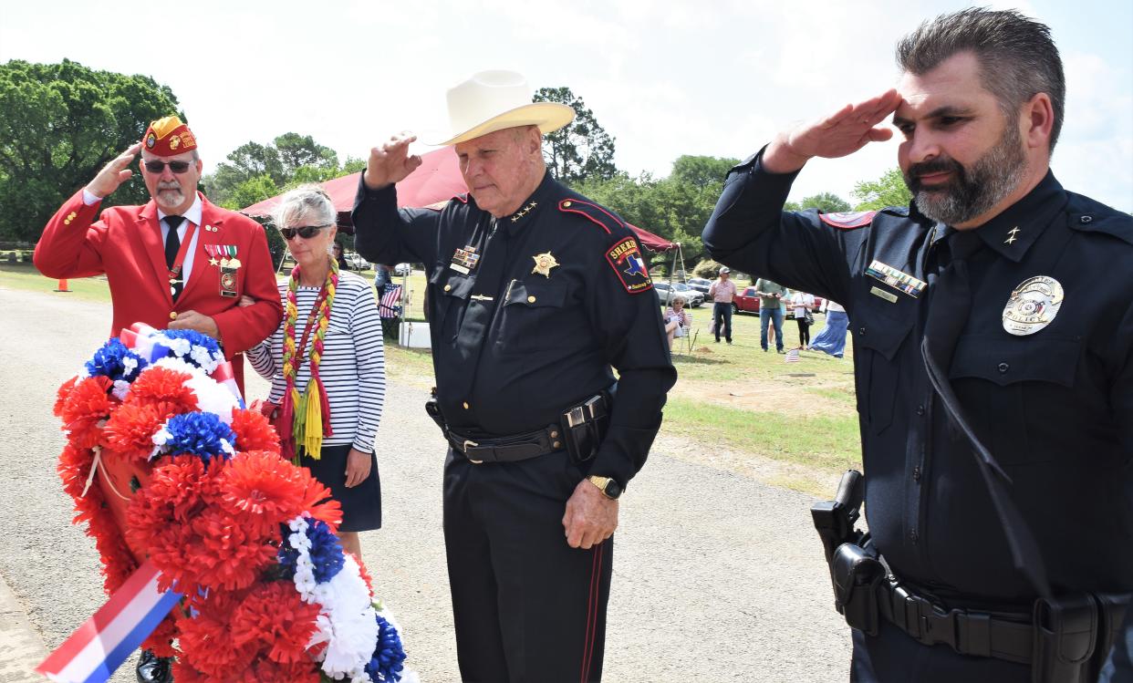 From left: Retired Col. Anthony Poletti, Charla Ann King, Bastrop County Sheriff Maurice Cook, and Bastrop Police Department Chief Clint Nagy lay a wreath honoring King’s husband, the late Marine Sgt. Timothy “Pat” Pugh, during the Memorial Day ceremony Monday at Fairview Cemetery.