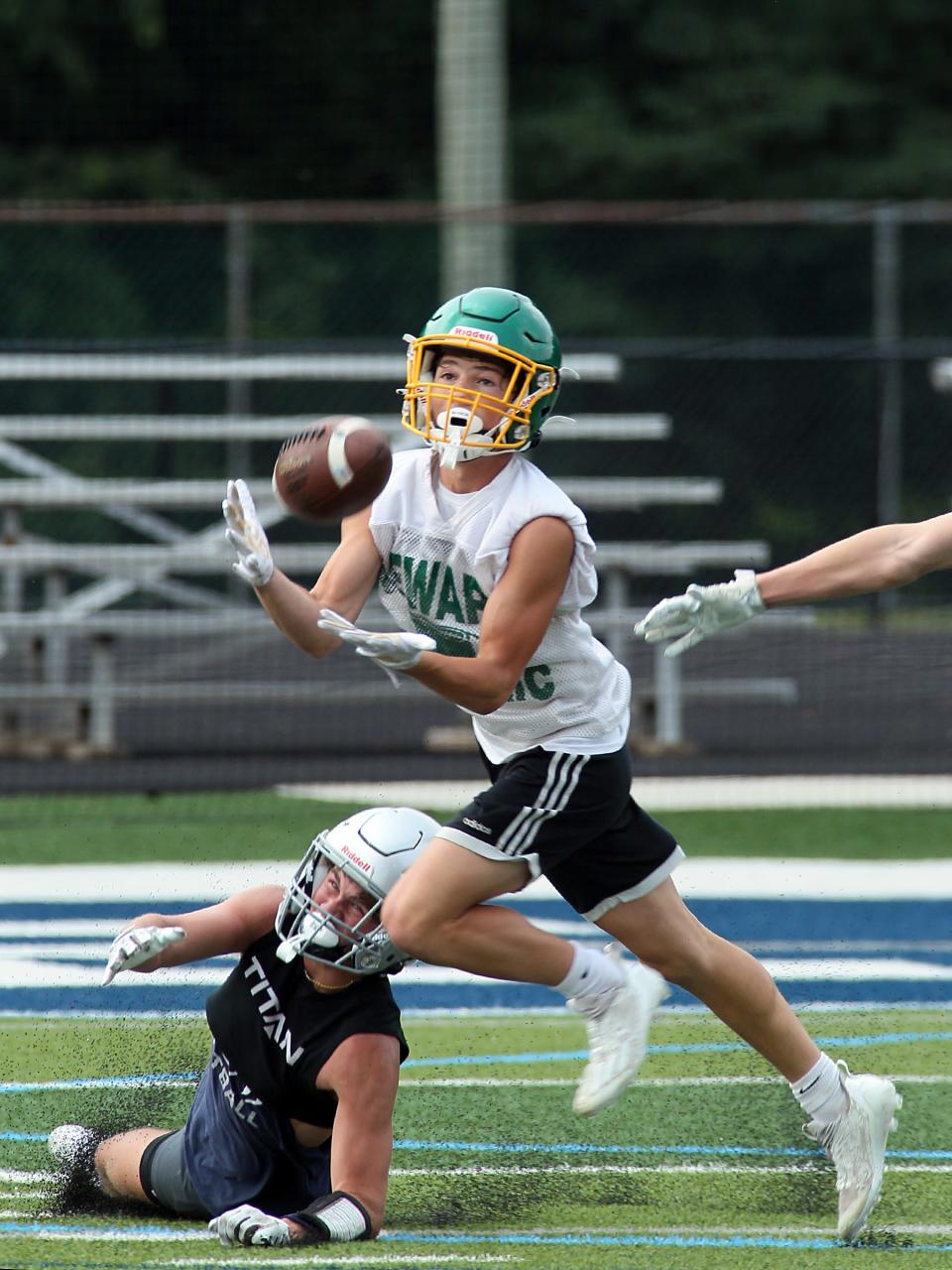 Newark Catholic's Henry Hitchens makes an interception during a scrimmage with Granville on Tuesday.