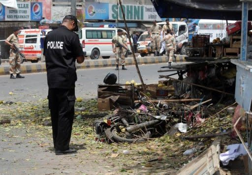 Pakistani paramilitary soldiers cordon-off the site of a suicide bomb attack in Karachi on Thursday. Karachi is Pakistan's largest city and its port has been a lifeline for US troops fighting the Taliban in landlocked Afghanistan, though Pakistan shut down the supply lines last November when US air strikes killed 24 soldiers