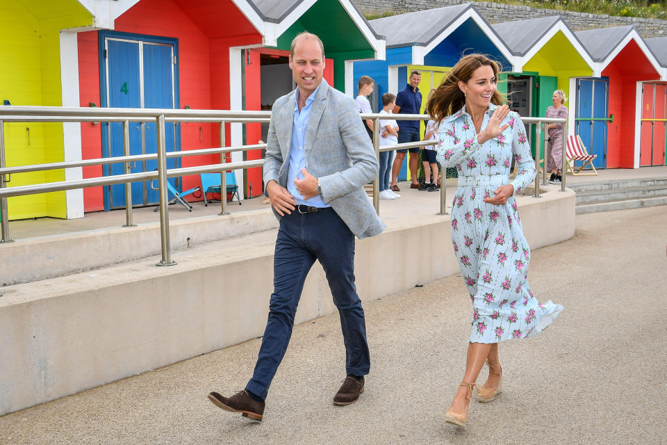 The Duke and Duchess of Cambridge wave to people on the beach as they leave the promenade after visiting beach huts, during their visit to Barry Island, South Wales, to speak to local business owners about the impact of COVID-19 on the tourism sector.