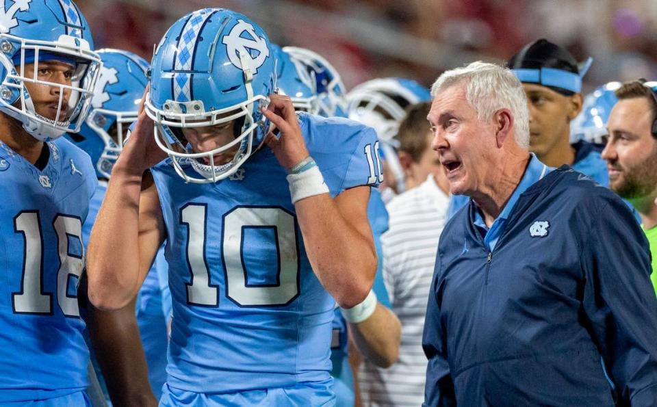 North Carolina coach Mack Brown has a word with quarterback Drake Maye (10) after a touchdown pass to John Copenhaver in the third quarter against South Carolina on Saturday September 2, 2023 at Bank of America Stadium in Charlotte, N.C.