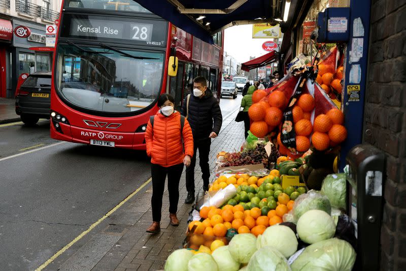 FILE PHOTO: People walk on a shopping street in London, Britain