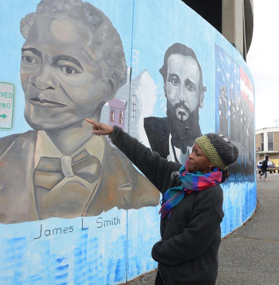 Artist Emida Roller of Putnam talks about her painting on a mural on the Market Street Garage in downtown Norwich. The men and women of color on the mural depict freedom, civil rights and human rights thoughout our history. The artists who painted the mural are Samson Tonton of Taftville and Emida Roller of Putnam.