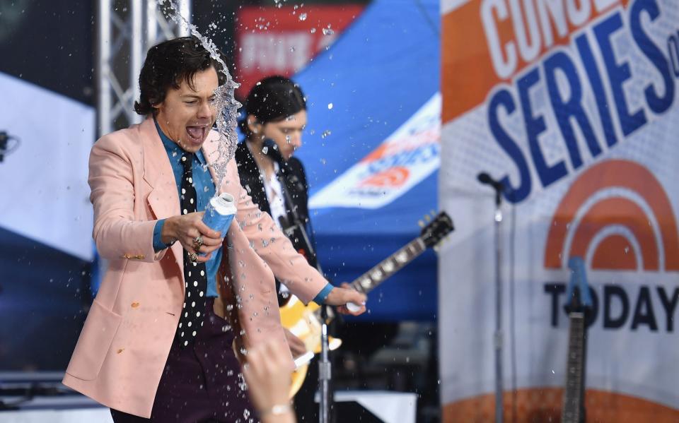 Styles covered himself - and the crowd - in water (AFP via Getty Images)