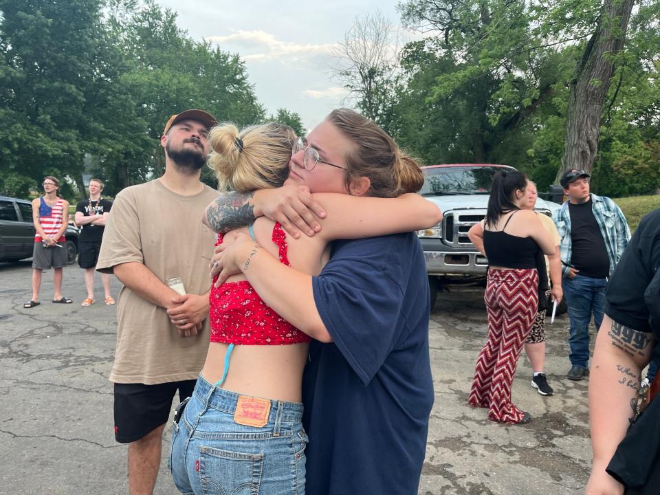 Celina Lindsay, 24, of New Franklin, right, hugs a friend during the vigil Thursday evening in Monument Park for Raychel Sheridan. "She didn't want people to be sad," Lindsay said. "She wanted there to be a celebration for her."