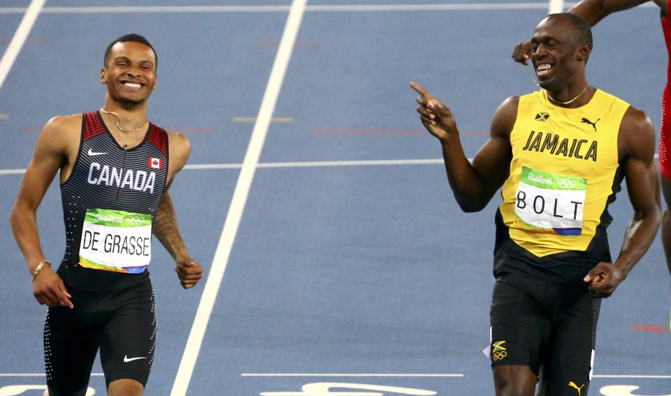 Usain Bolt and Andre De Grasse share a smile at the end of the 200m semifinal at the Rio 2016 Summer Olympics.