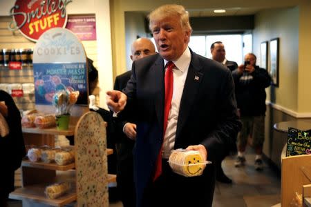 Republican U.S. presidential nominee Donald Trump and former New York City Mayor Rudolph Giuliani (rear L) make a stop to buy cookies at the Eat'n Park restaurant in Moon Township, Pennsylvania, October 10, 2016. REUTERS/Mike Segar