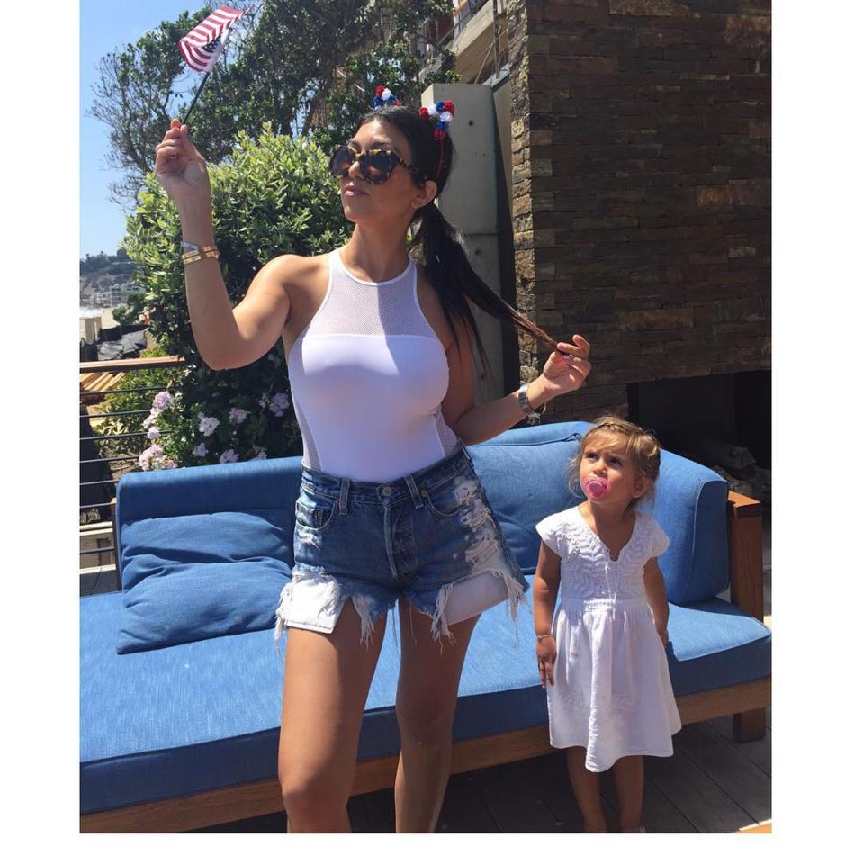 If actions speak louder than words, both Kourtney Kardashian and Scott Disick are saying a whole lot -- kind of. Kardashian has stayed mum while her boyfriend and father of their children -- Mason, 5, Penelope, 2, and Reign, six months -- has been spotted partying in Monte Carlo with his ex, Chloe Bartoli. <strong>NEWS: Scott Gets Touchy-Feely With a Woman Who Isn't Kourtney </strong> Instead, the mom-of-three has been sharing family photos. She posted two patriotic pics of herself waving an American flag, including one with an adorable bubblegum-popping Penelope standing close by. Friday night, the 36-year-old <em>Keeping up with the Kardashians</em> star took an equally sweet snap of Mason and Reign's feet from her mom-and-son pajama party. <strong>PHOTOS: Celebs Get Patriotic on Fourth of July</strong> Kardashian has not spoken publicly about Disick's European jaunt, but not only was her longtime love partying with a number of women while she was back in the States, a source tells ET that Disick was also drinking and passed out in the middle of the day. The 32-year-old busnessman had checked into a rehab facility in Costa Rica back in March. Splash News In the midst of Disick's seemingly shady situation, Kardashian is making it clear that her children come first. The most telling photo of all, however, may have been her Instagram on Thursday -- the gun range romp was captioned, "Don’t mess." Those sure sound like some passive-aggressive (though mostly aggressive) fighting words! Find out if Disick was paid for his recent rehab stint in the exclusive video below.