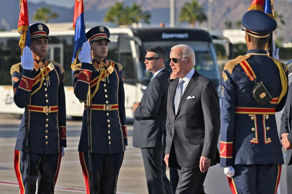 President Joe Biden is greeted by honor guards upon his arrival at the airport of Egypt's Red Sea resort city of Sharm El-Sheikh to attend the COP27 climate conference on Friday.