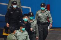 Pro-democracy activist Joshua Wong walks to a prison van to head to court with other activists, over a national security law charge, in Hong Kong