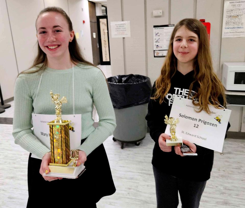 Champion Mary Hamilton of St. Edwards School and runner-up Solomon Prigozen, also a St. Edwards student, proudly hold their trophies after the Ashland County Spelling Bee Tuesday evening.