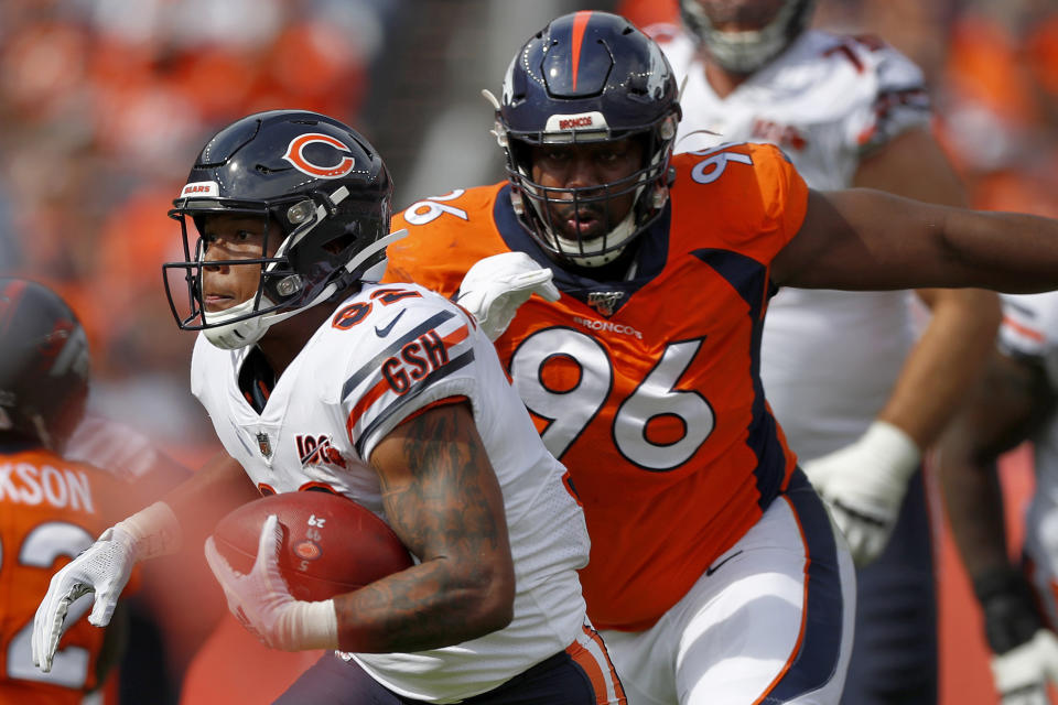 FILE - Chicago Bears running back David Montgomery is pursued by Denver Broncos defensive tackle Shelby Harris during the first half of an NFL football game in Denver, in this Sunday, Sept. 15, 2019, file photo. After missing four games because of COVID-19, Harris will return to the Broncos' lineup when Denver travels to Kansas City to face the Chiefs on Sunday evening. (AP Photo/David Zalubowski, File)