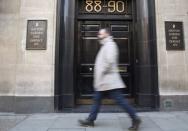 A man passes a safe deposit building on Hatton Garden in central London. Burglars are believed to have broken into the Hatton Garden Safe Deposit company over the Easter weekend, local media reported. April 7, 2015. REUTERS/Neil Hall