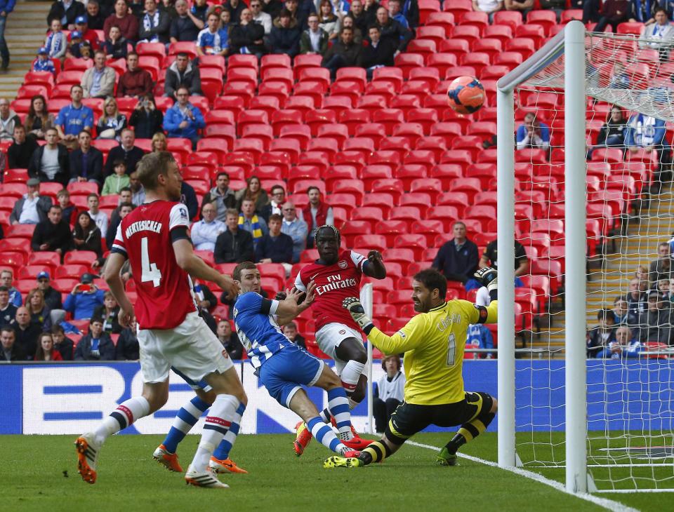 Arsenal's Bacary Sagna (2nd R) shoots over the bar from close range against Wigan Athletic during their English FA Cup semi-final soccer match at Wembley Stadium in London April 12, 2014. REUTERS/Eddie Keogh (BRITAIN - Tags: SPORT SOCCER)