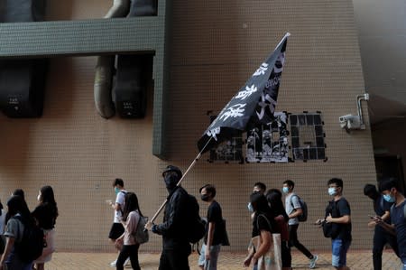 Students at Hong Kong Baptist University take part in a rally after police entered the campus on Sunday while chasing protesters, in Hong Kong