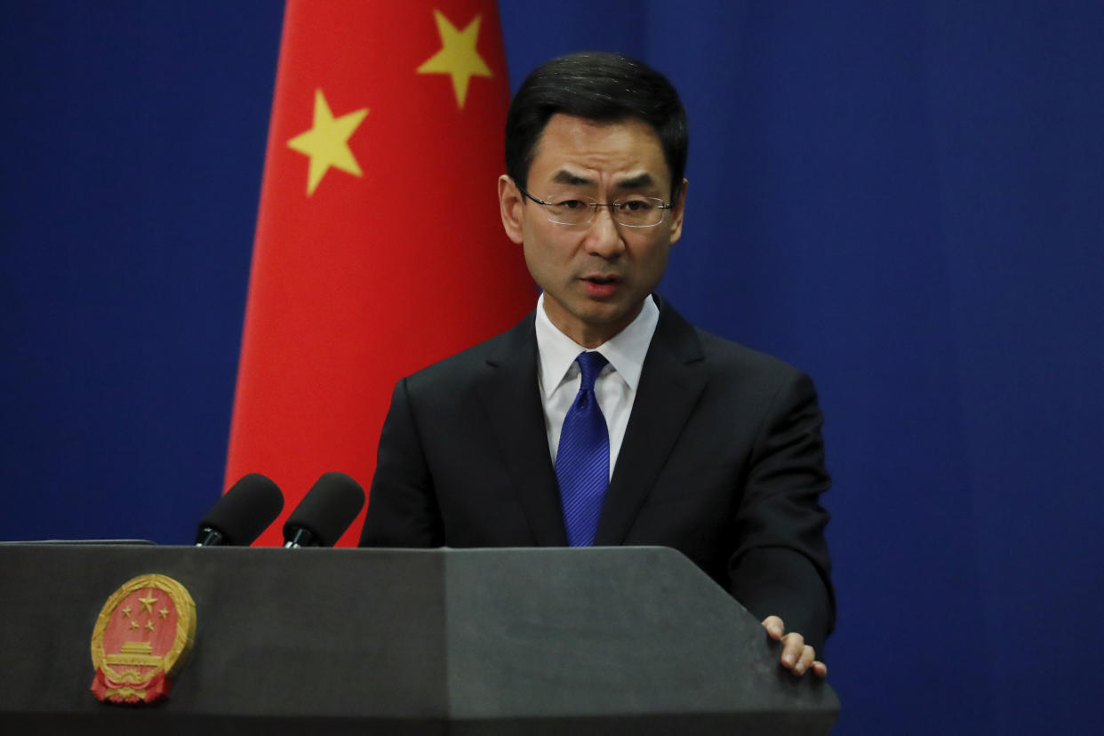 Chinese Foreign Ministry spokesman Geng Shuang speaks during a daily briefing at the Ministry of Foreign Affairs office in Beijing, Wednesday, March 18, 2020. At least 13 American journalists stand to be expelled from China in retaliation for a new limit imposed by the Trump administration on visas for Chinese state-owned media operating in the U.S. (AP Photo/Andy Wong)