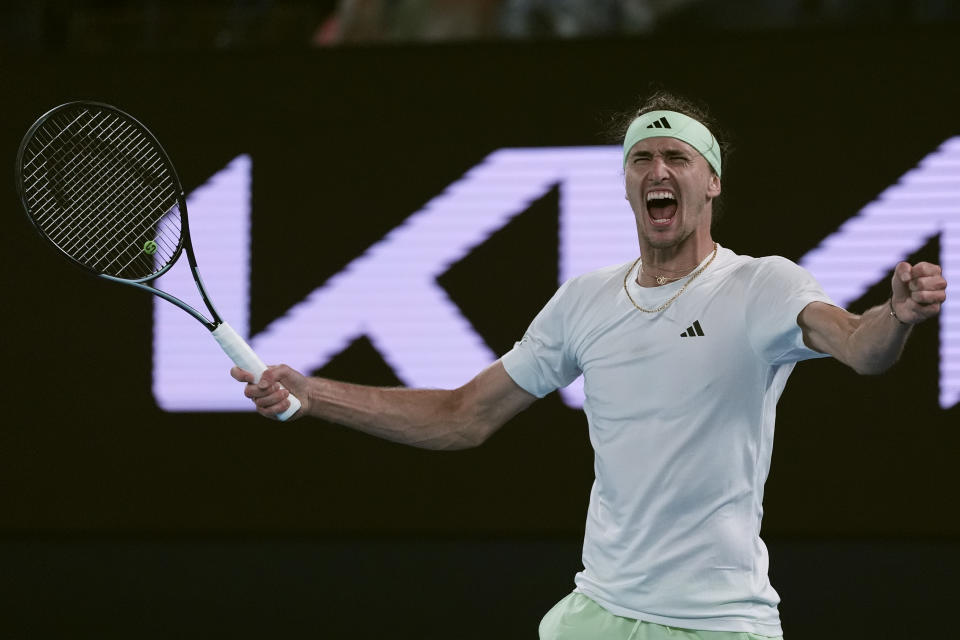 Alexander Zverev of Germany celebrates after defeating Carlos Alcaraz of Spain in their quarterfinal match at the Australian Open tennis championships at Melbourne Park, Melbourne, Australia, early Thursday, Jan. 25, 2024. (AP Photo/Andy Wong)