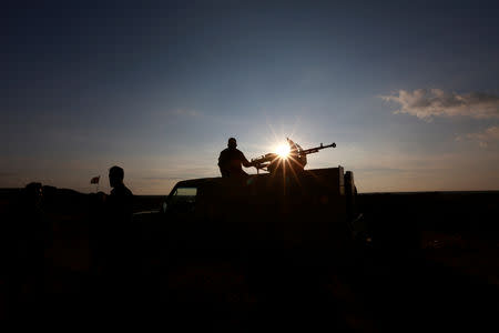 A Popular Mobilisation Forces (PMF) fighter rides in a military vehicle at the Iraqi-Syrian border near al-Qaim, Iraq, November 26, 2018. REUTERS/Alaa al-Marjani