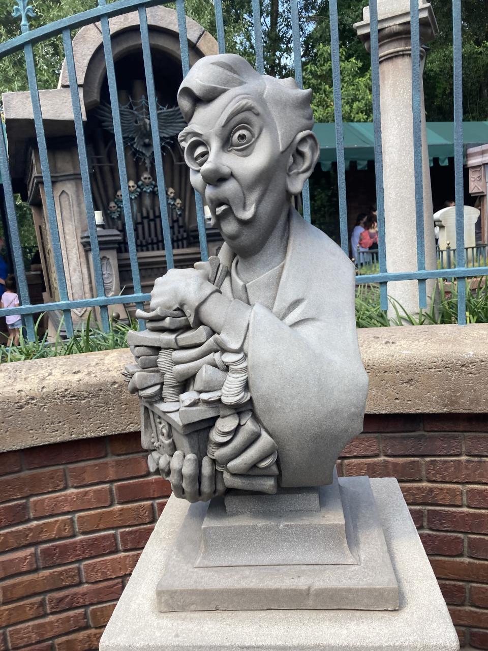 A bust at the front of the queue for Haunted Mansion