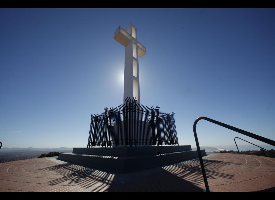 The sunlight glows through the cross at Mt. Soledad Memorial Thursday, Feb. 9, 2012 in San Diego. The Mt. Soledad Memorial Association is petitioning the Supreme Court to stop the demolition of the cross mandated by a ACLU lawsuit that claims the cross in unconstitutional because it violates the Establishment Clause of the Constitution. (AP Photo/Lenny Ignelzi)