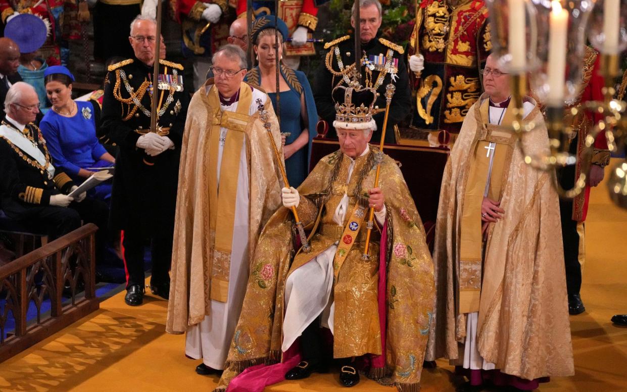 The King looks on after being crowned with the St Edward's Crown by The Archbishop of Canterbury Justin Welby