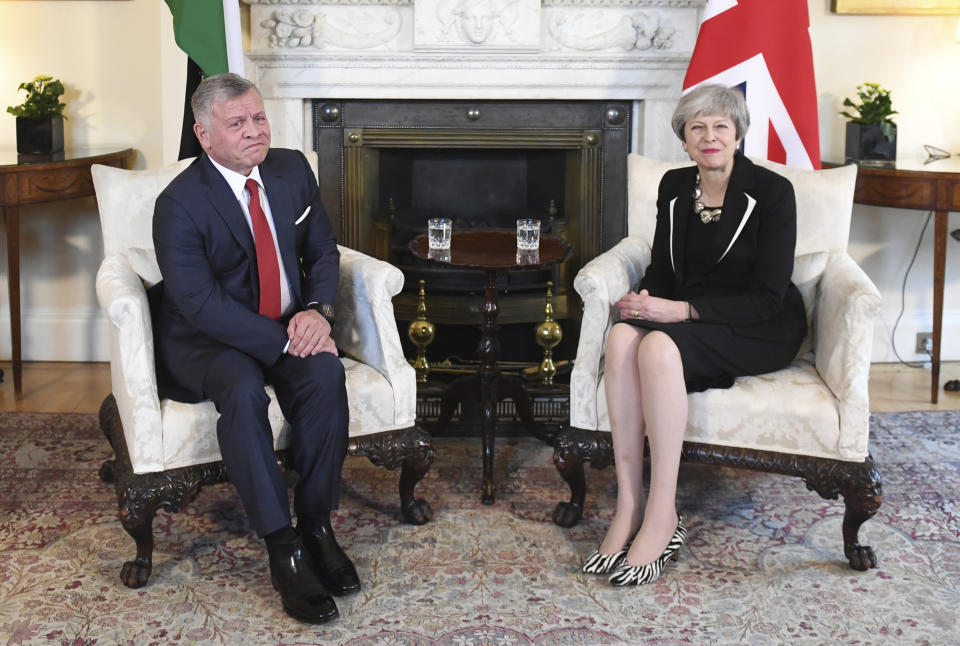 Britain's Prime Minister Theresa May and King Abdullah II of Jordan pose for a photo inside 10 Downing Street in London, Thursday Feb. 28, 2019. (Stefan Rousseau/PA via AP)