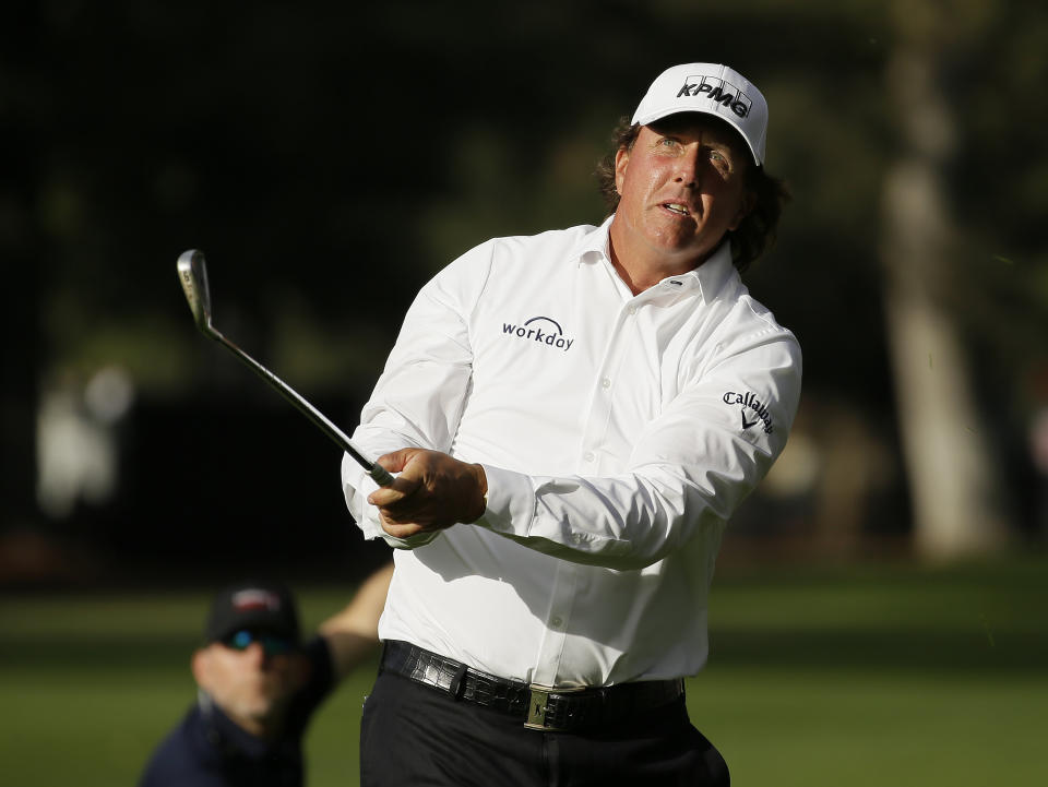 Phil Mickelson watches his shot from the fairway to the 18th green of the Silverado Resort North Course during the first round of the Safeway Open PGA golf tournament Thursday, Oct. 4, 2018, in Napa, Calif. Mickelson shot a 7-under-par 65. (AP Photo/Eric Risberg)
