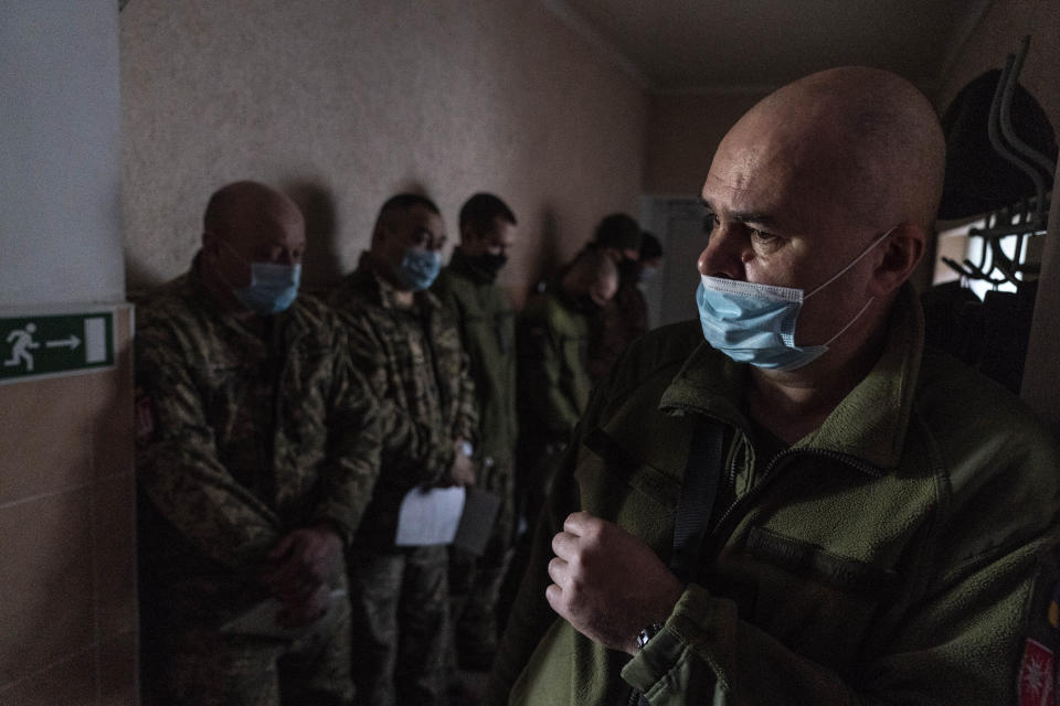 Ukrainian servicemen wait to receive a dose of the AstraZeneca COVID-19 vaccine marketed under the name CoviShield at a military base in Kramatorsk, Ukraine, Tuesday, March 2, 2021. Ukraine plans to vaccinate 14.4 million people this year, or about 35% of its 41 million people. (AP Photo/Evgeniy Maloletka)