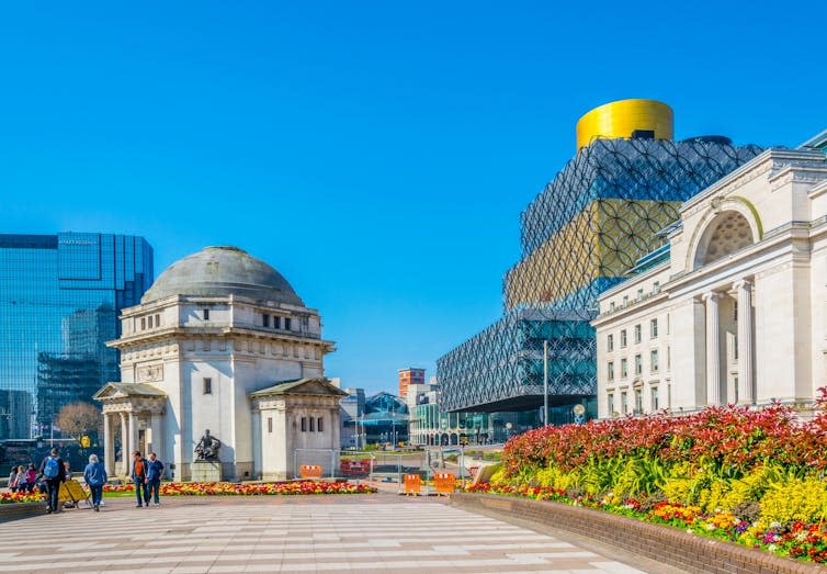 A city centre under a blue sky.