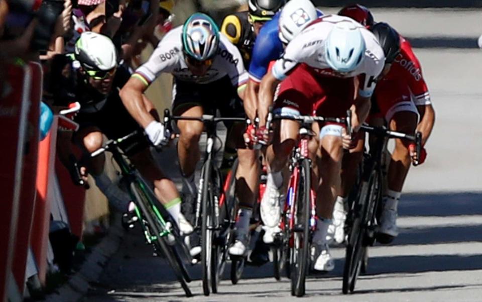 Mark Cavendish (left) is elbowed into the barriers by world champion Peter Sagan - EPA