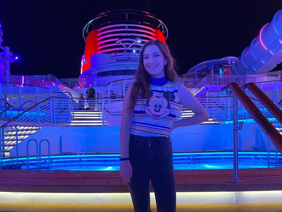 Reporter Amanda Krause on the Disney Wish cruise ship at night.