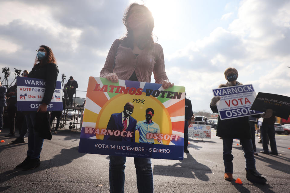 People attend a rally with former Democratic presidential candidate Julián Castro and Jon Ossoff, Georgia Democratic candidate for the U.S. Senate, on Dec. 7. (Photo by Spencer Platt/Getty Images)