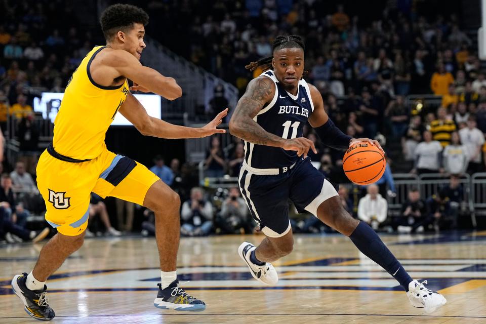 Jan 10, 2024; Milwaukee, Wisconsin, USA; Butler Bulldogs guard Jahmyl Telfort (11) drives towards the basket against Marquette Golden Eagles forward Oso Ighodaro (13) during the first half at Fiserv Forum. Mandatory Credit: Jeff Hanisch-USA TODAY Sports