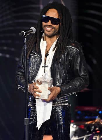 <p>ROBYN BECK/AFP via Getty Images</p> Lenny Kravitz accepts his award at the Recording Academy Honor in Los Angeles on Feb. 1, 2024