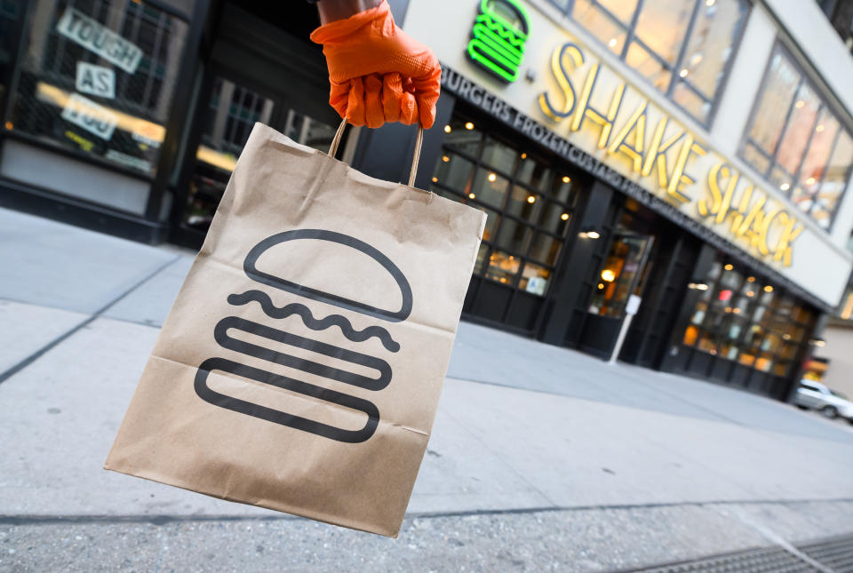 NEW YORK, NEW YORK - APRIL 22: A person wearing a protective glove holds a bag outside Shake Shack during the coronavirus pandemic on April 20, 2020 in New York City. COVID-19 has spread to most countries around the world, claiming over 184,000 lives lost with over 2.6 million infections reported. (Photo by Noam Galai/Getty Images)