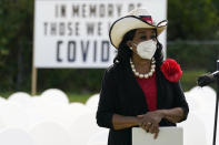 Congresswoman Frederica Wilson, D-Fla., listens during a news conference at a symbolic cemetery created o remember and honor lives lost to COVID-19, Tuesday, Nov. 24, 2020, in the Liberty City neighborhood of Miami. Officials announced that a new COVID-19 testing site will be opening in the neighborhood. (AP Photo/Lynne Sladky)