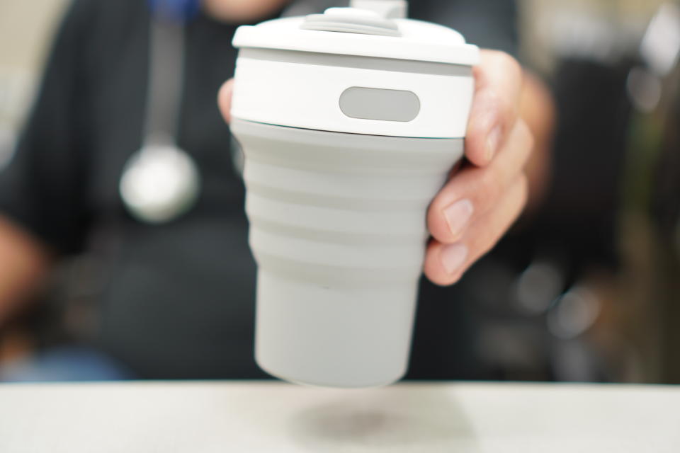 Image of holding a cup of elastic coffee in clinic.