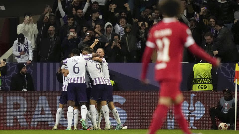 Toulouse's players celebrate after scoring their third goal against Liverpool. - Thibault Camus/AP