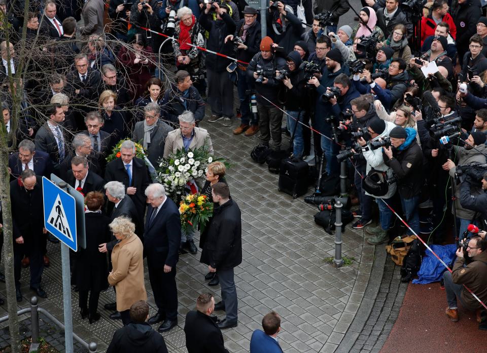 (L-R) German Justice Minister Christine Lambrecht, German Interior Minister Horst Seehofer, Hesse's State Premier Volker Bouffier and Hesse state Interior Minister Peter Beuth arrive to lay flowers in the area of the bar targeted in a shooting at the Heumarkt in the centre of Hanau, near Frankfurt am Main, western Germany, on February 20, 2020, after at least nine people were killed in two shootings late on February 19, 2020. - The suspect in two shootings in Germany that killed at least nine people was found dead at home, police said on February 20, 2020. At least nine people were killed in two shootings late on February 19 in Hanau, near the German city of Frankfurt. (Photo by Odd ANDERSEN / AFP) (Photo by ODD ANDERSEN/AFP via Getty Images)